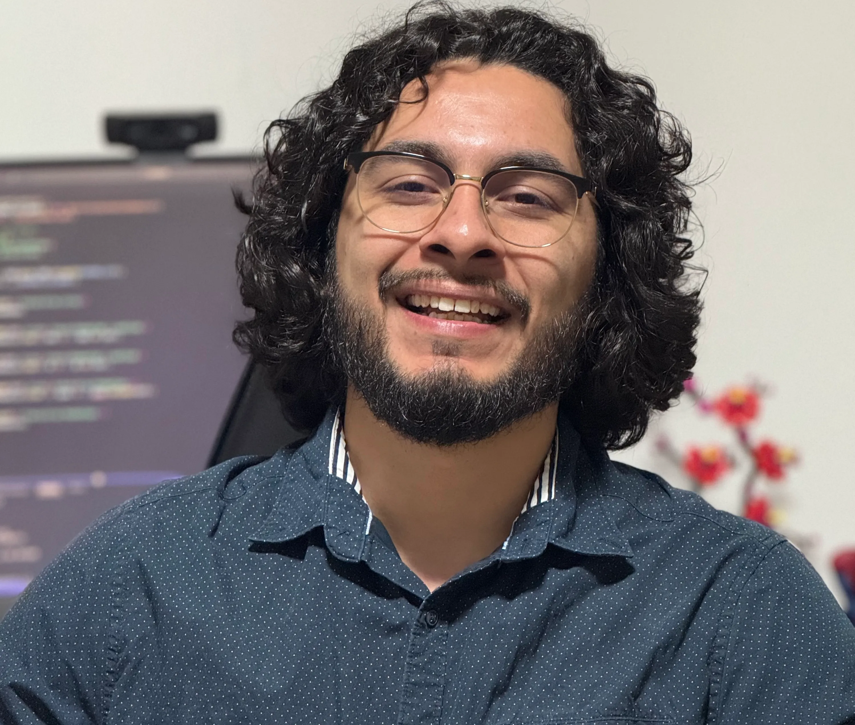Ivan Carrillo, head-and-shoulders portrait, smiling, neutral background